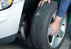 Mechanic working on tire of a car